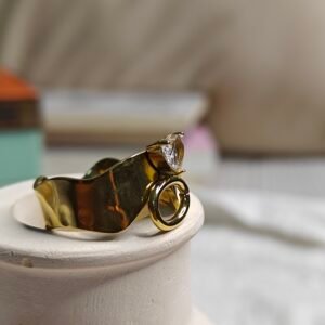 The Rhea Ring – Sculpted Gold Band with Dangling Loop & Crystal